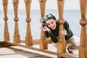 Attractive girl takes pictures with an old camera photo