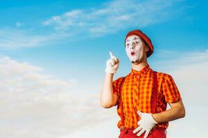 Mime shows pantomime against the blue sky photo