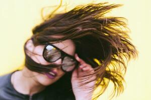 Model posing for photographer on a yellow background photo