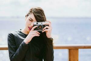 Attractive girl takes pictures with an old camera photo