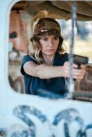 A girl with a pistol in her hand undergoes military training and learns to shoot. photo