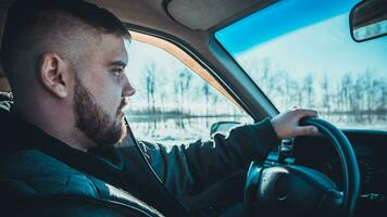 bearded man sitting behind the wheel of the Russian photo