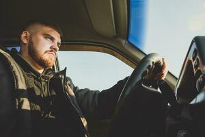 bearded man sitting behind the wheel of the Russian photo