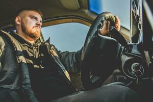 bearded man sitting behind the wheel of the Russian photo