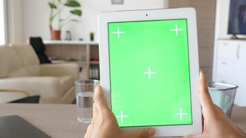 Slow sliding over a digital tablet PC with green screen chroma mockup in comfy living room in the house. video