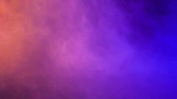 Abstract and dynamic moving colorful clouds of smoke over a black background video