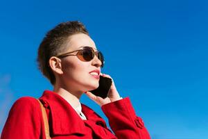 Girl model with phone on blurred background photo