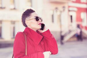 Girl model with phone on blurred background photo