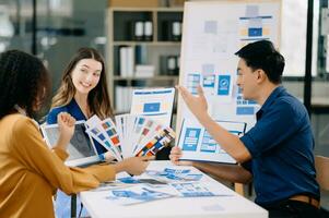 Team business people meeting in office. Employee brainstorm and work plan and discuss project by point on paper and tablet. photo
