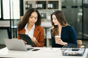 Female discussing new project with male colleague. Young woman talking with young man photo