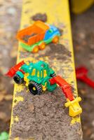 children's toys in the sandbox close-up photo