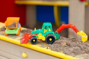 children's toys in the sandbox close-up photo