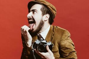 very positive photographer posing in studio with film camera photo