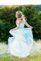 bride posing for the photographer on the nature photo