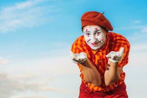 Mime shows pantomime against the blue sky photo