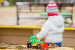 child playing excavator on the street photo