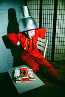 Mime put a metal lampshade on his head, makes faces and poses photo