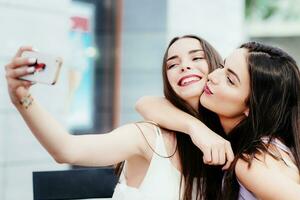 Girls make a rest in coffee and make selfies photo