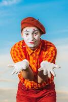 Mime shows pantomime against the blue sky photo