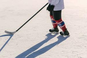 the man plays hockey on the rink photo