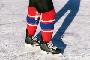 hockey skates close-up during a game on ice photo