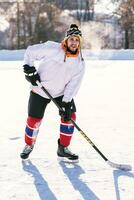 the man plays hockey on the rink photo