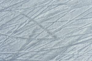 traces on the ice from skates on the rink photo