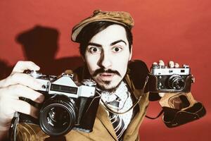 very positive photographer posing in studio with cameras photo