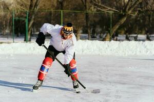 the man plays hockey on the rink photo