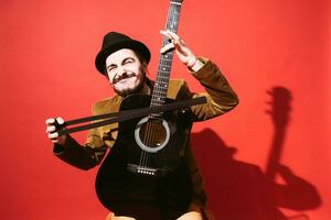 positive guy playing guitar in the Studio photo