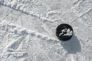 hockey puck lies on the ice in the stadium photo