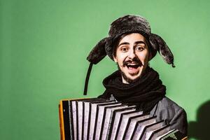 a very positive man with an accordion posing in the studio photo