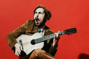 positive guy playing guitar in the Studio photo