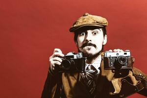 very positive photographer posing in studio with cameras photo