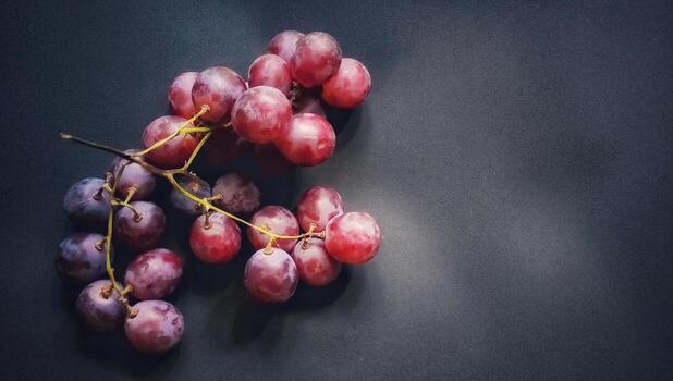 Top view of vitis vinifera fruits or red grapes isolated on a black background photo