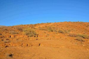 a hill with a blue sky in the background photo