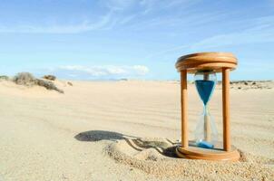 an hourglass in the sand on a sunny day photo