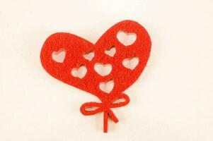 a red felt heart with hearts cut out of it photo