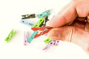 a person holding a piece of clothes pegs photo