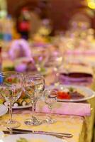 Served festive table with snacks, glasses, glasses, cutlery and napkins for a banquet photo