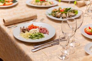 Served festive table with snacks, glasses, glasses, cutlery and napkins for a banquet photo