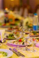 Served festive table with snacks, glasses, glasses, cutlery and napkins for a banquet photo