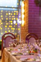 Served festive table with snacks, glasses, glasses, cutlery and napkins for a banquet photo