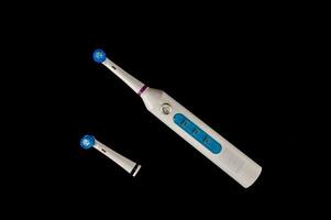 a toothbrush and a toothbrush head on a black surface photo