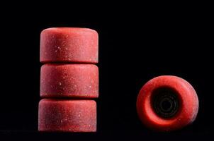 red skateboard wheels on a black background photo