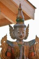 a wooden statue of a buddha with wings photo