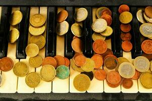 a piano keyboard with coins on it photo