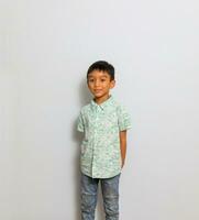 Cute little boy in casual outfit on background photo