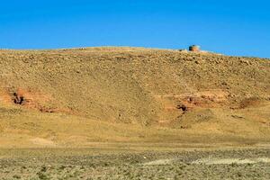 a hill with a small building on it photo