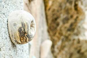 a rock with a hole in it on a wall photo